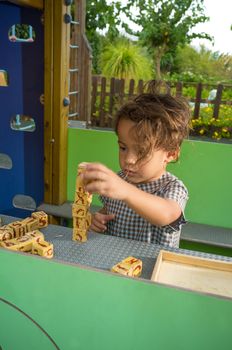 Girl playing with an old alphabet puzzle game