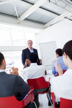 Business people applauding the speaker after the conference. Business concept.