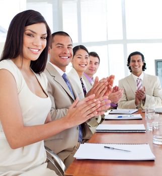 Multi-ethnic business team applauding after a conference in a company
