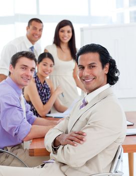 Self-assured businessman in a meeting with his team