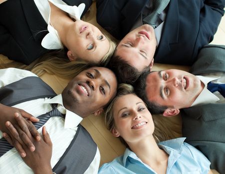 Closse-up of Business people lying in a circle on the floor of the office
