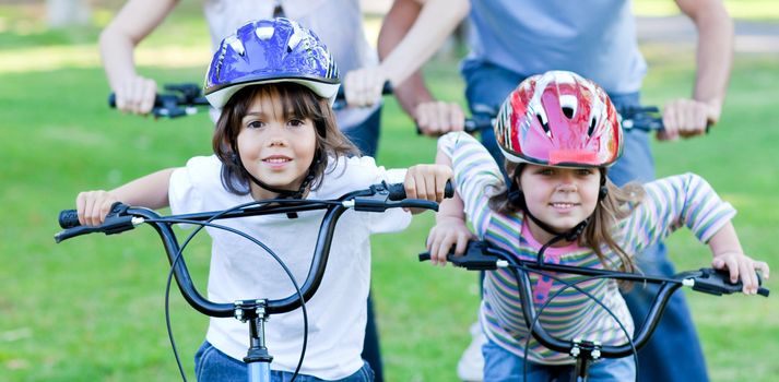 Jolly children riding a bike in a park