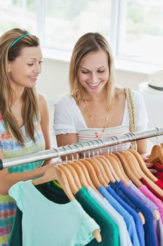 Caucasian women choosing clothes together in a shop 