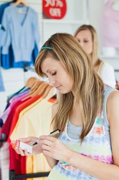 Happy women choosing clothes together in a shop 