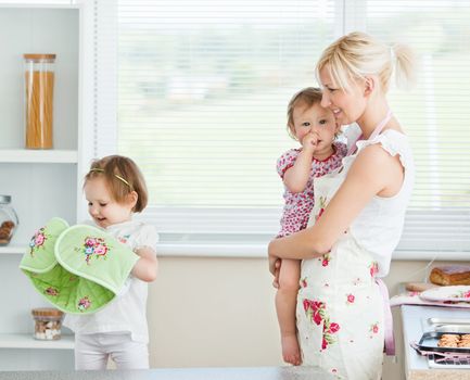 Mother having fun with her daughters in living room