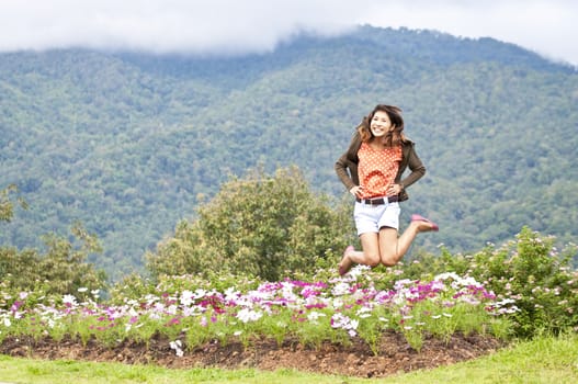 Portrait Of Asian Young Woman In garden on the mountain in winter season