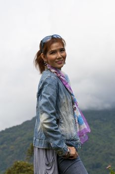 Portrait Of Asian Young Woman In garden on the mountain in winter season