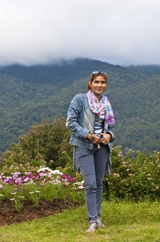 Portrait Of Asian Young Woman In garden on the mountain in winter season