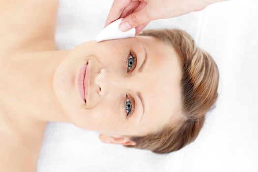 Attractive young woman receiving a beauty treatment in a spa center