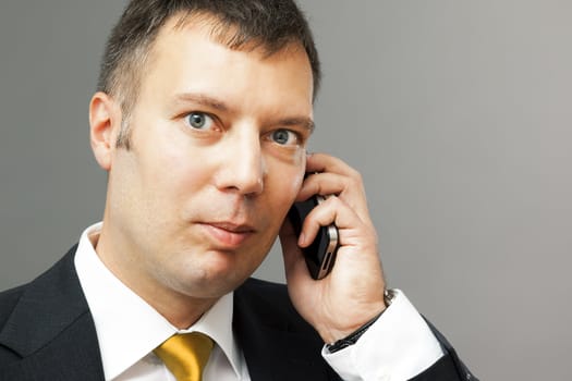 An image of a business man with his mobile phone