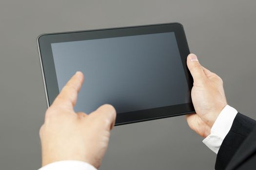 An image of a handsome business man pointing to his tablet pc