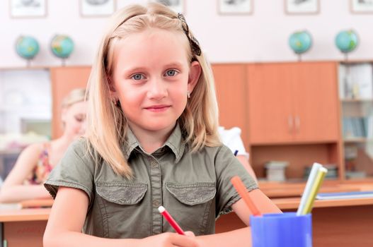 portrait of students in the classroom, sit at school desks