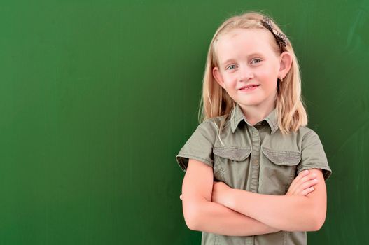 schoolgirl portrait near the blackboards, looking at the camera