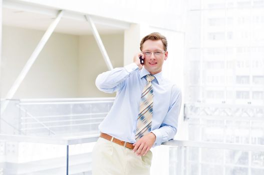 Smiling business man, talking on cell phone