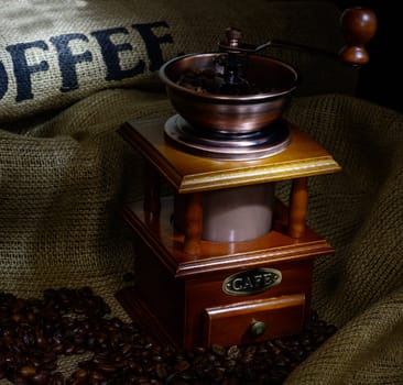 Coffee Mill with beans and burlap. still life