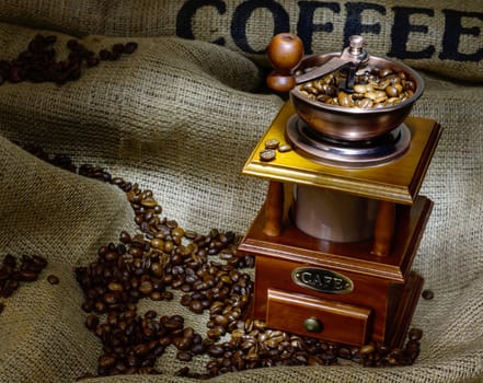 Coffee Mill with beans and burlap. still life