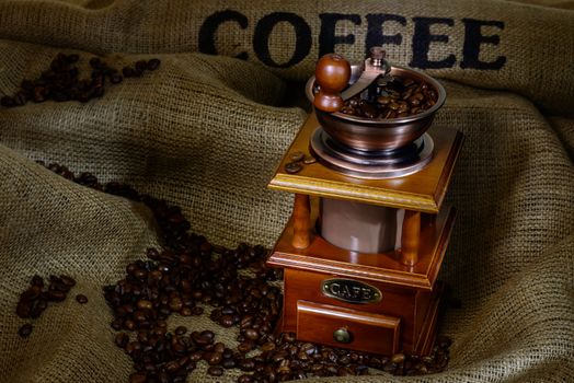 Coffee Mill with beans and burlap. still life