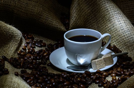 Coffee cup,  beans and burlap. still life