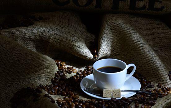 Coffee cup,  beans and burlap. still life