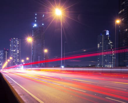 Light in car on city streets at night in Bangkok, Thailand.