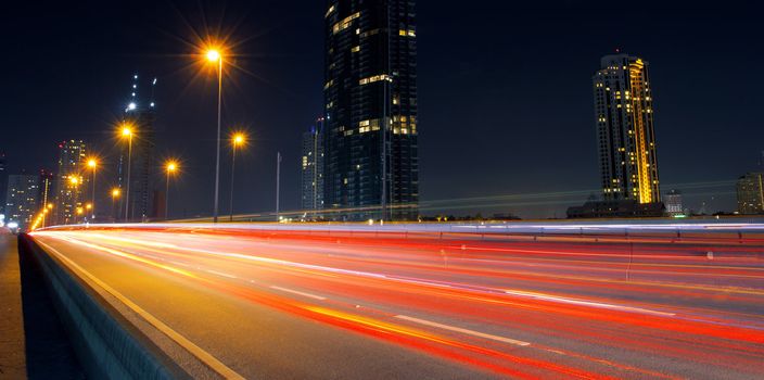 Light in car on city streets at night in Bangkok, Thailand.