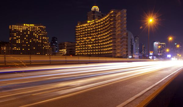 Light in car on city streets at night in Bangkok, Thailand.