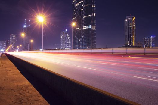 Light in car on city streets at night in Bangkok, Thailand.