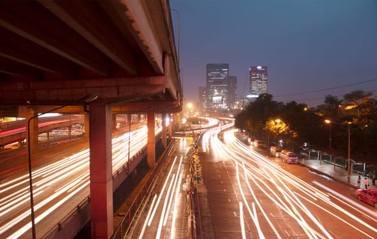 Light in car on city streets at night in Bangkok, Thailand.