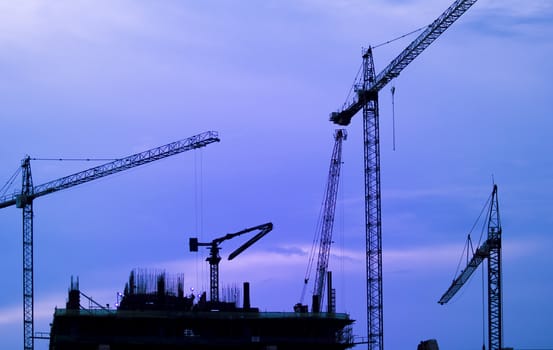 Building Construction with Cranes in the evening.