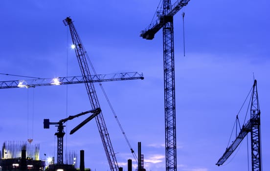 Building Construction with Cranes in the evening.