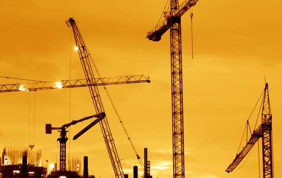 Building Construction with Cranes in the evening.