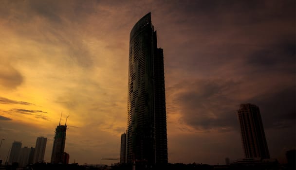 Modern skyscrapers in the evening with orange light in Bangkok Thailand.