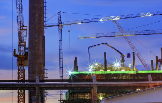 Construction work. Tower cranes are used to complete the task quickly.