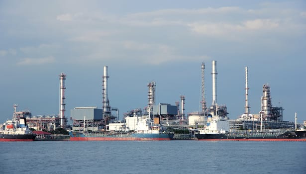 River and oil refinery factory with reflection in Bangkok, Thailand.