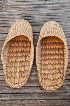 handmade slippers from dry water hyacinth on old bamboo floor