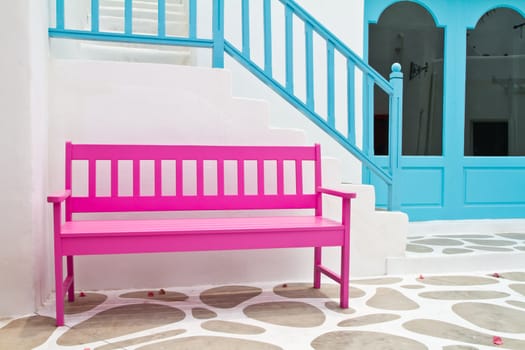 Pink chair on pathway and blue stair