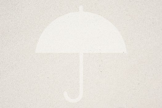 Umbrella icon on sand background and textured 