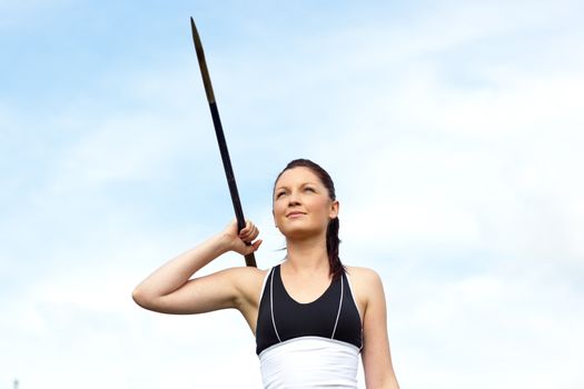 Female athlete throwing the javelin outdoors