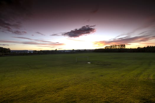 Beautiful Sunset in Stirling Scotland over an empty football field