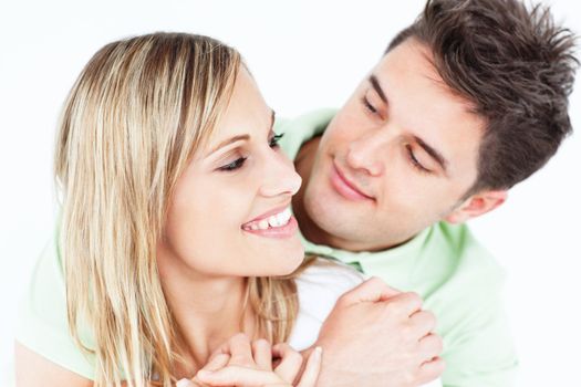 Young attractive people looking each other with love against a white background