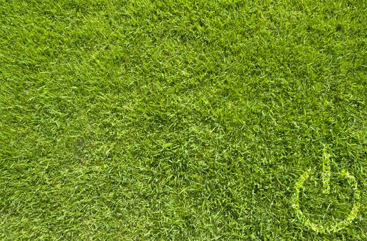 Shutdown icon on green grass texture and background 