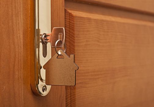 A key in a lock with house icon on it 