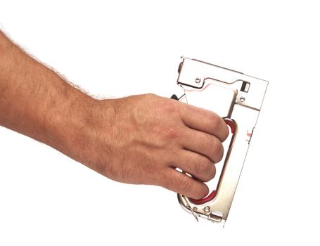 Hand holding a stapler for repair of furniture 