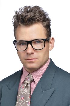 Closeup of nerdy executive businessman with messy hair style and clashing suit