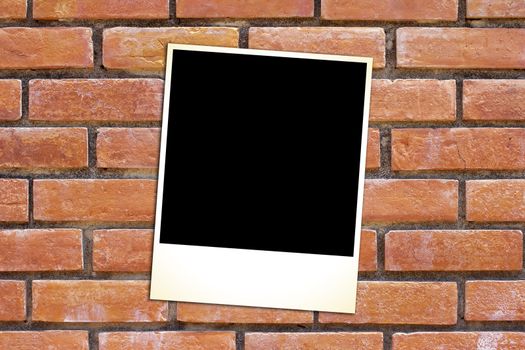 blank vintage paper and photo frame on brick background