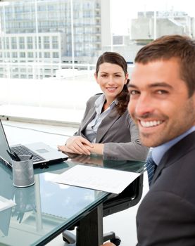 Two positive business people smiling at the camera during an interview