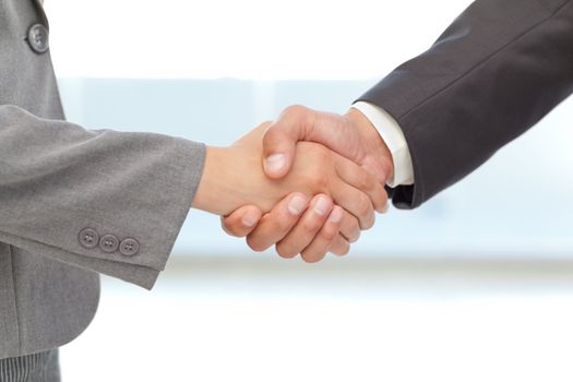 Handshake between two business people at work