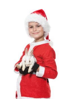 Boy holding a christmas rabbit isolated on white background