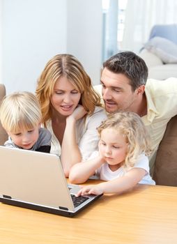Family looking at their laptop at home