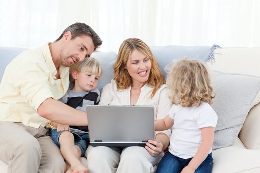 Family looking at their laptop at home